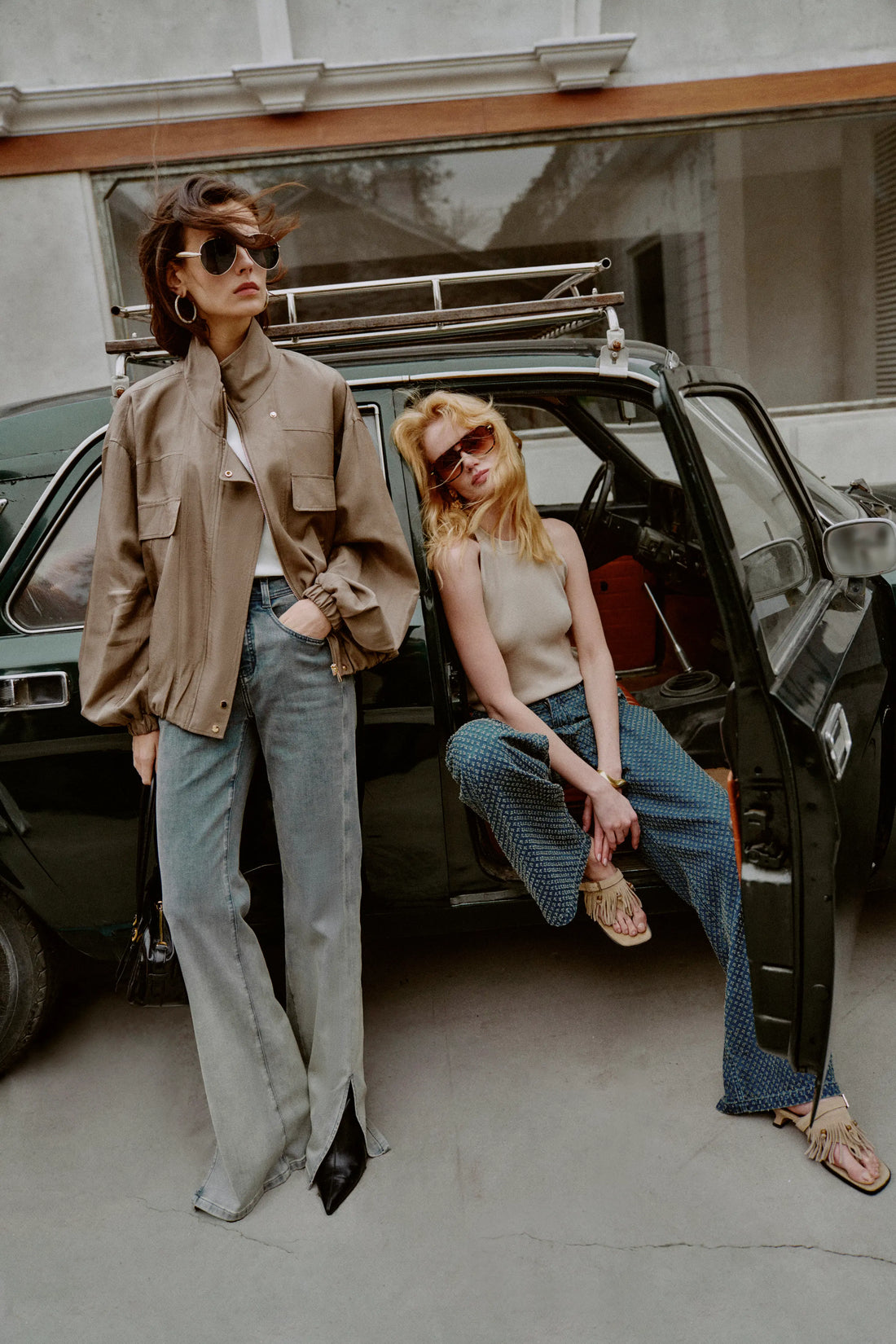 Woman wearing a taupe satin acetate jacket with stand collar and utility pocket details